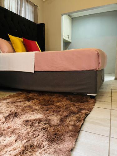 a bedroom with a large bed with a rug at Ashridge Guesthouse & Safaris in Hazyview