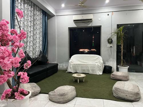 a living room with a couch and a bed at Hotel Tulsi Inn in Haldwāni