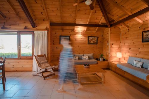 a person walking through a living room in a log cabin at Il Belvedere in Punta del Este