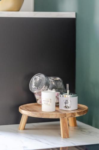 a small wooden table with some items on it at Sauna Moments Villa in Torhout