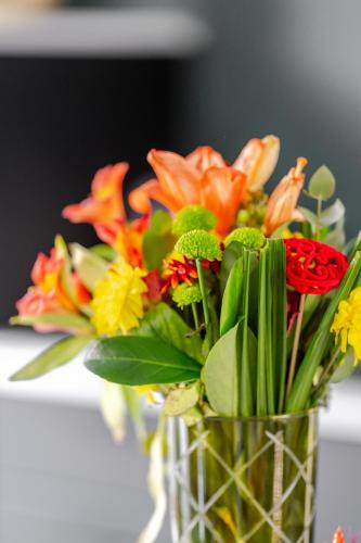 a vase filled with flowers sitting on a table at Sauna Moments Villa in Torhout