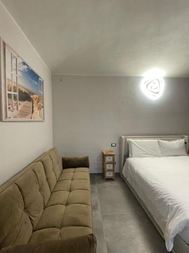 a living room with a bed and a couch at airport apartments camera relax in San Maurizio Canavese