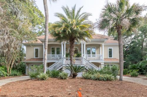 a house with palm trees in front of it at Counting Stars! - Retreat on Fripp Island in Fripp Island