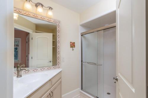 a bathroom with a shower and a sink and a mirror at Counting Stars! - Retreat on Fripp Island in Fripp Island