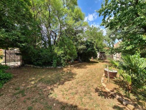 une cour vide avec des arbres et une clôture dans l'établissement Ferienhaus für 6 Personen ca 90 qm in Krnica, Istrien Bucht von Raša, à Krnica