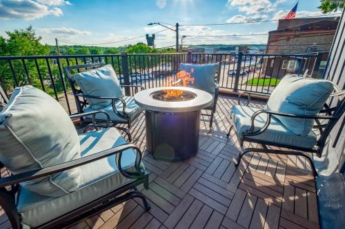 a patio with two chairs and a fire pit on a balcony at The Cove Guest House in Prescott