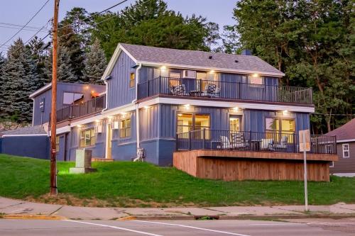 a large blue house with a large deck at The Cove Guest House in Prescott