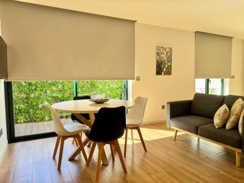 a living room with a table and a couch at RIACENTRUM - Smart Residence in Aveiro