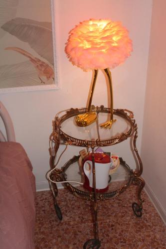 a lamp on a table with a cup on it at Art b&b Gli Aironi in Pomposa
