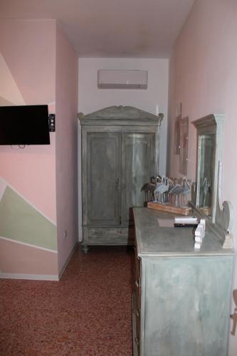 a room with a large wooden cabinet in a room at Art b&b Gli Aironi in Pomposa