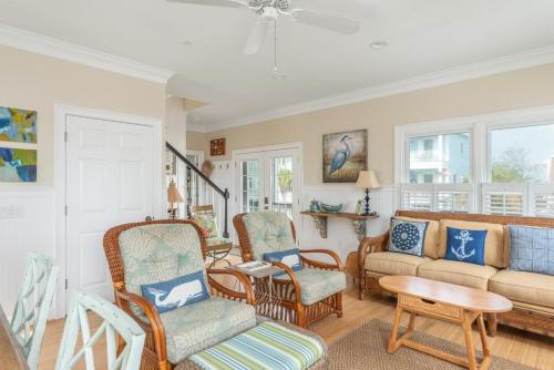 a living room with chairs and a couch at Shipwatch Beach House - Ocean Views! Shared Pool! in Cedar Reef Villas