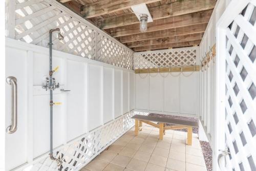 an empty room with a wooden bench in it at Shipwatch Beach House - Ocean Views! Shared Pool! in Cedar Reef Villas