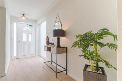 a hallway with a mirror and a potted plant at Casa da Hortência do Faial in Faial