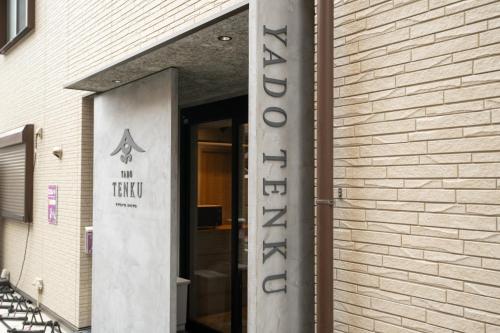 a entrance to a building with a sign on it at YADO TENKU Kyoto Nijo in Kyoto