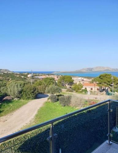 a balcony with a view of a beach and the ocean at La Pelosa House 1 in Stintino