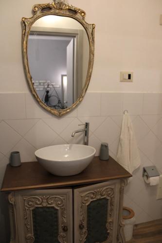 a bathroom with a sink and a mirror at Art b&b Gli Aironi in Pomposa