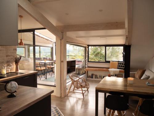 a kitchen and living room with a table and chairs at Appartement sur les toits, très jolie vue Provence in Gréoux-les-Bains