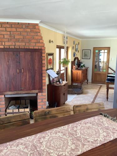 a living room with a brick fireplace and a couch at Scherers Ecke in Hentiesbaai