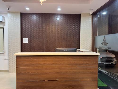 a reception desk in a room with a car at Hotel Apex Inn Hyderabad Airport in Hyderabad
