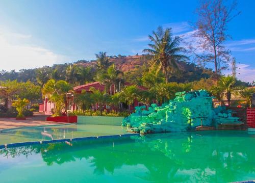 a water slide in the middle of a pool at Whispering Woods Resort in Lonavala