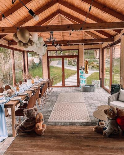 two teddy bears are sitting at tables in a pavilion at Siedlisko przy Młynie in Cisze