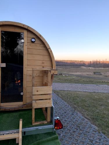 a wooden out house on the side of a field at Siedlisko przy Młynie in Cisze