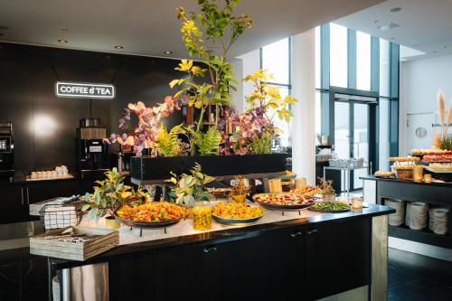 a buffet with many bowls of food on a table at Clarion Hotel Trondheim in Trondheim