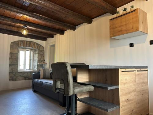 a kitchen with a bar and a couch in a room at Casa Anka in Gračišće