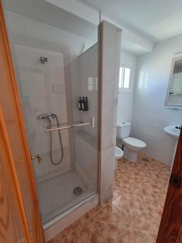a bathroom with a shower and a toilet at 3ºB Escobar in Nerja