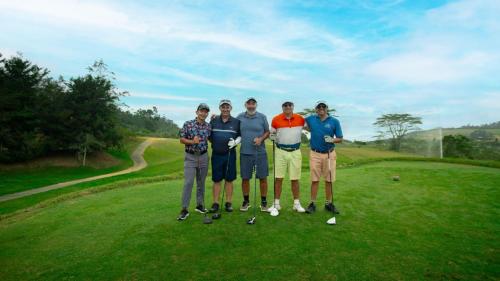 a group of people standing on a golf course at Casa de Campo in Los Santos