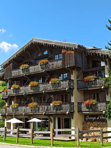 a building with flower boxes on the balconies at Hôtel La Grange d'Arly in Megève