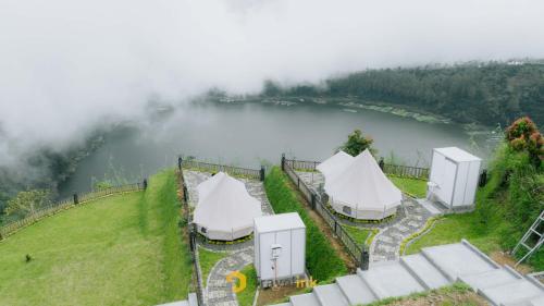 an aerial view of tents next to a lake at Glamping Telaga Menjer By Travelink in Kejajar