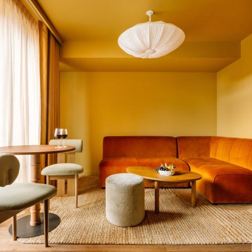 a living room with a couch and a table at Le Jardin de Verre by Locke in Paris