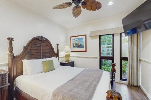a bedroom with a bed and a ceiling fan at Kaha Lani 104 in Lihue