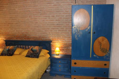 a bedroom with a blue dresser next to a bed at Art b&b Gli Aironi in Pomposa