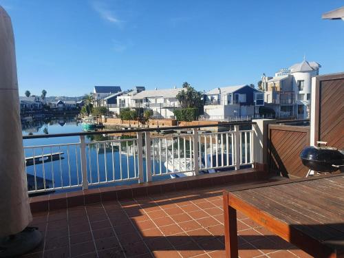 a balcony with a view of a body of water at Knysna Quays Waterfront Accomodation in Knysna