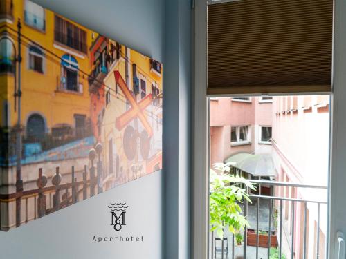 a window with a picture of a building at MARIENSZTAT 8 Aparthotel in Warsaw
