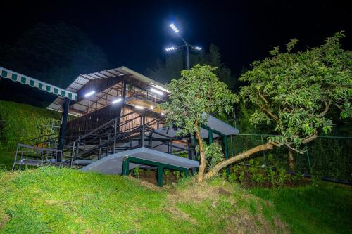 a building with a bench in front of it at night at La Parada House in Heredia