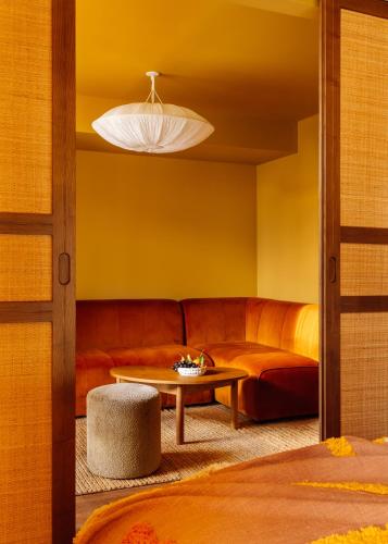 a living room with a couch and a table at Le Jardin de Verre by Locke in Paris