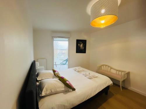 a bedroom with a bed and a window at Presqu'île de Caen, Terrasse & Parking in Caen