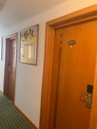 a room with a door and a picture on the wall at Hotel Jasmine in Braşov