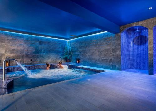 two people in a jacuzzi in a swimming pool at night at The Lodges at Kilkea Castle in Kilkea