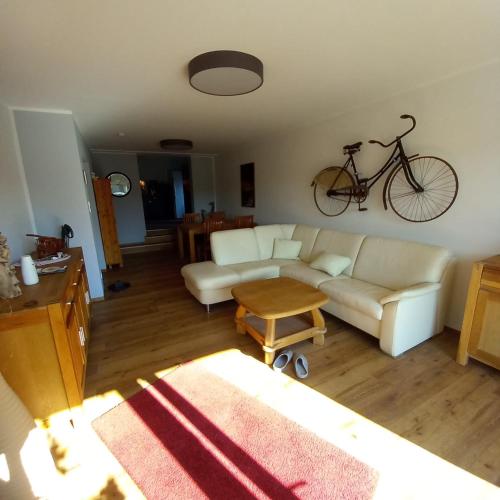 a living room with a couch and a bike hanging on the wall at Hartmannshof in Bedburg Hau