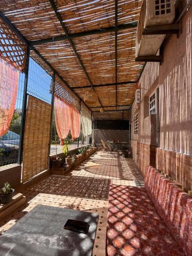 an empty room with a wooden ceiling and windows at Dar SAÏDA in Marrakech