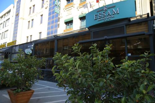 a store with trees in front of a building at Essam Deluxe Hotel in Baku