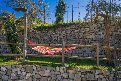 a hammock hanging on a stone wall at L'antica Pigna Chateau in Vico Equense