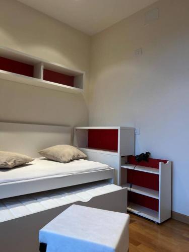 a bedroom with two bunk beds and a white bedvisor at Inserrata Abetone in Tuscany in Abetone