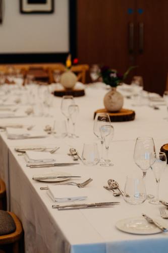 a long table with glasses and silverware on it at The Fleece at Ruleholme in Carlisle