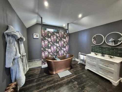 a bathroom with a tub and a sink at Squirrel Cottage in Ballymena