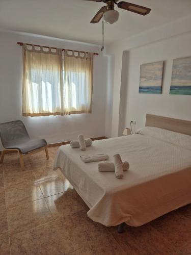 a bedroom with a large bed with two towels on it at 2ºA Escobar in Nerja